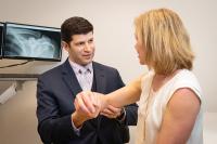 Doctor and patient discussing an arm injury.